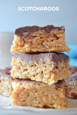 a three-high stack of scotcharoo bars on a white lacy plate against a white background.