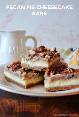 three pecan pie cheesecake bars stacked on a little gold and white plate against a white and wooden background.