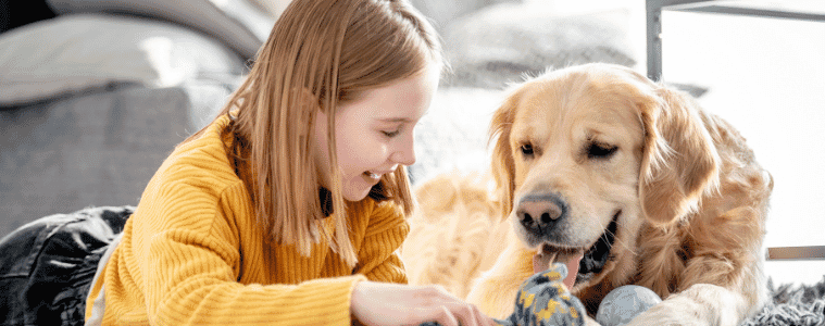 little girl lying with her dog on the floor 