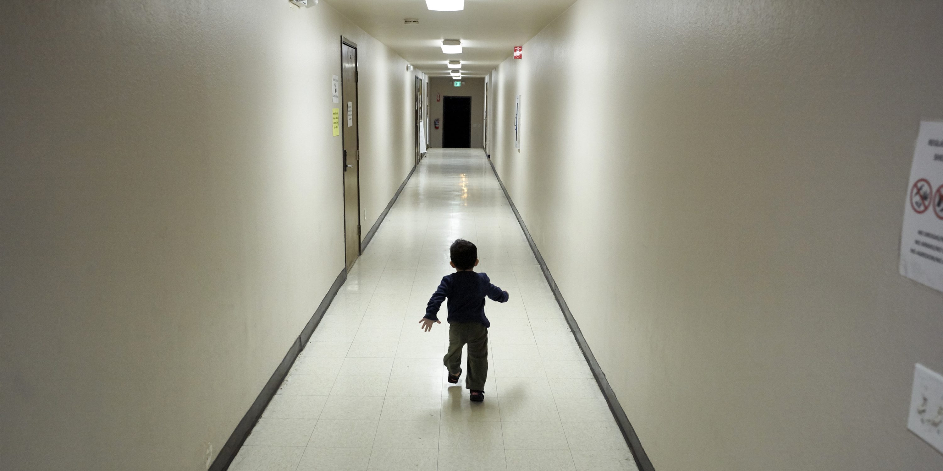 FILE - In this Dec. 11, 2018, file photo, an asylum-seeking boy from Central America runs down a hallway after arriving from an immigration detention center to a shelter in San Diego. A court-appointed committee has yet to find the parents of 628 children separated at the border early in the Trump administration. (AP Photo/Gregory Bull, File)