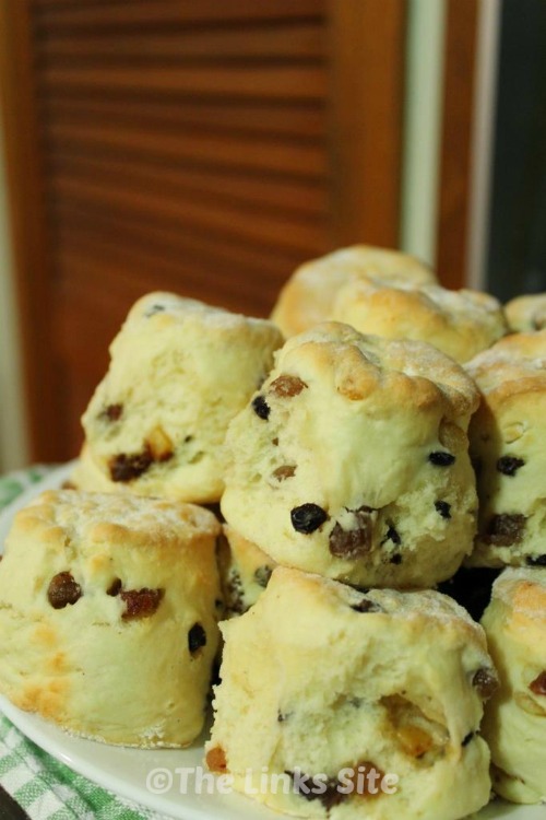 Fruit scones stacked on a plate.