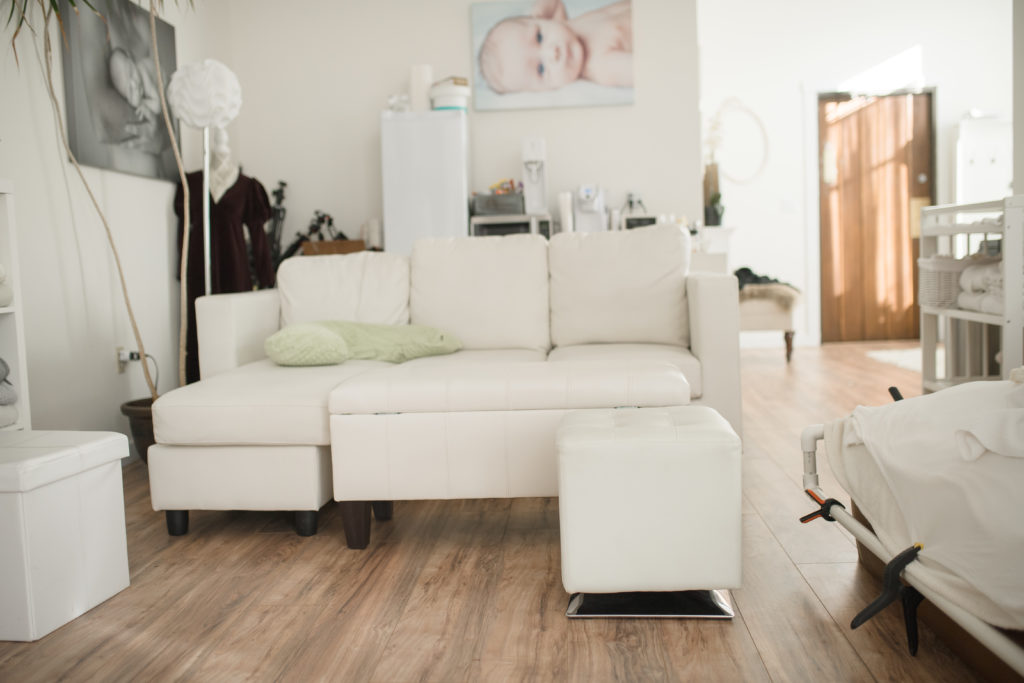 white couch in newborn studio