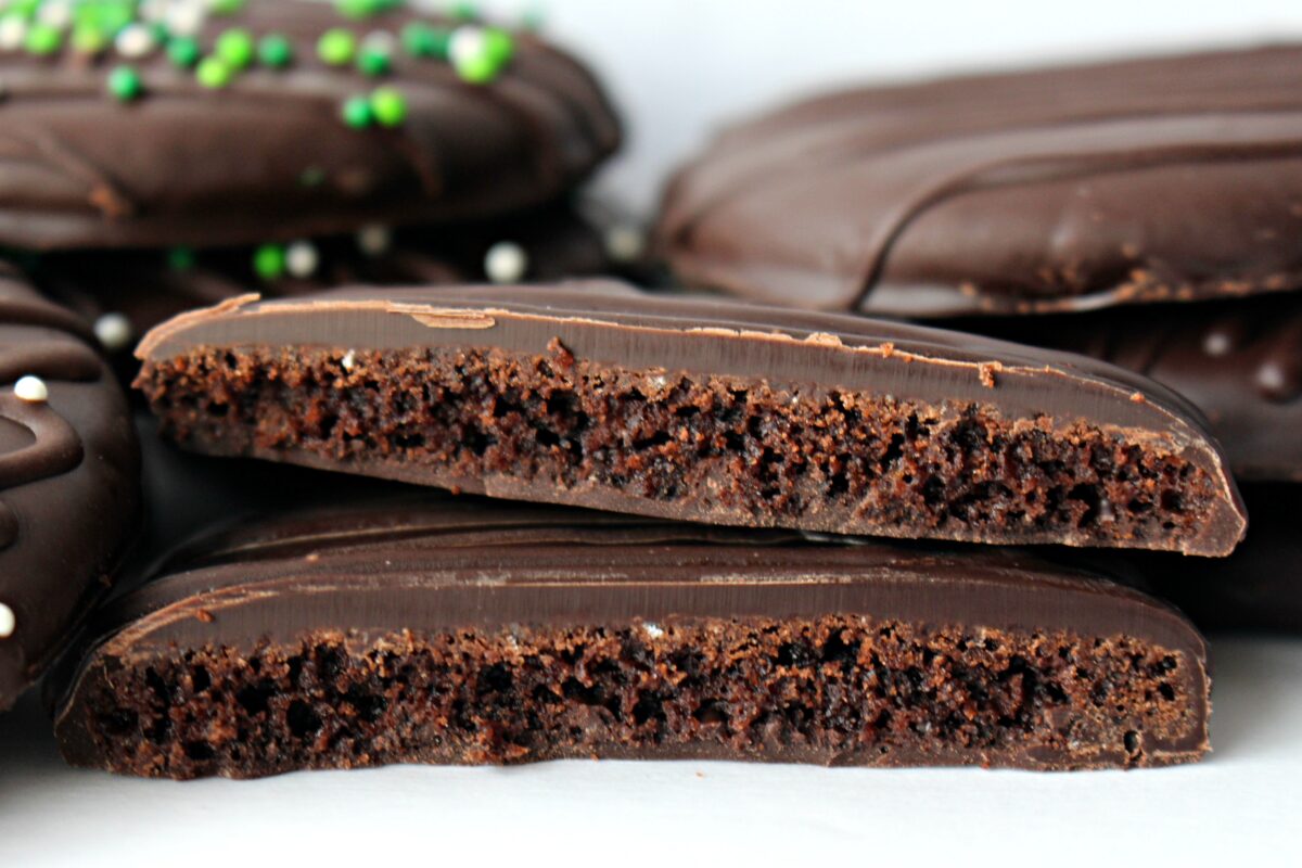 Closeup of a cookie cut in half to show the chocolate wafer surrounded with chocolate.