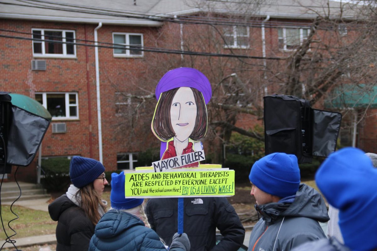 Union members and supporters hold up a sign condemning Mayor Ruthanne Fuller at the NTA rally Wednesday, Jan. 31. 