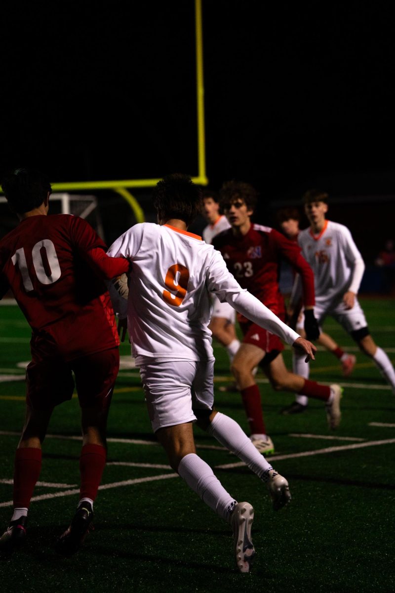 Senior Marco Comin Natick defenders to keep the offensive possession alive Wednesday, Nov. 13. 