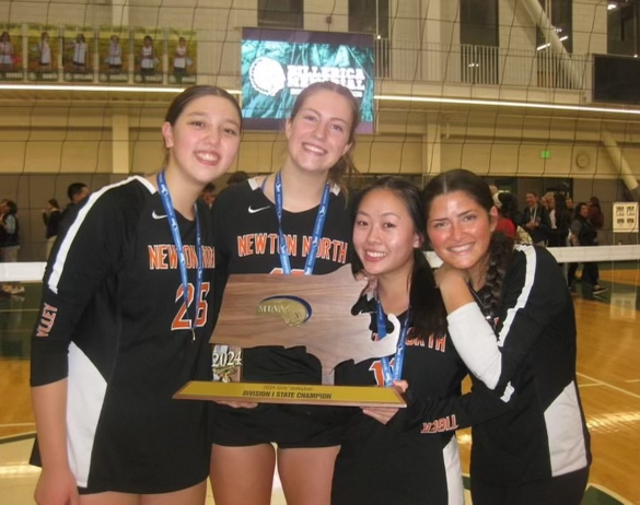 Members of girls' volleyball pose with their trophy Saturday, Nov. 16. 