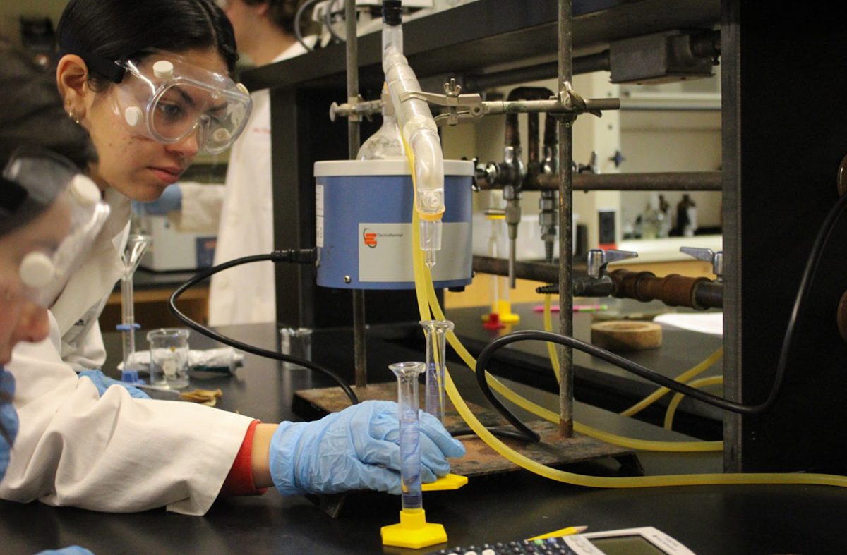 Friends seniors Kaya Banerjee and Charlotte Hassler conduct an experiment in Dr. Hoa Cost's Advanced Chemistry class.