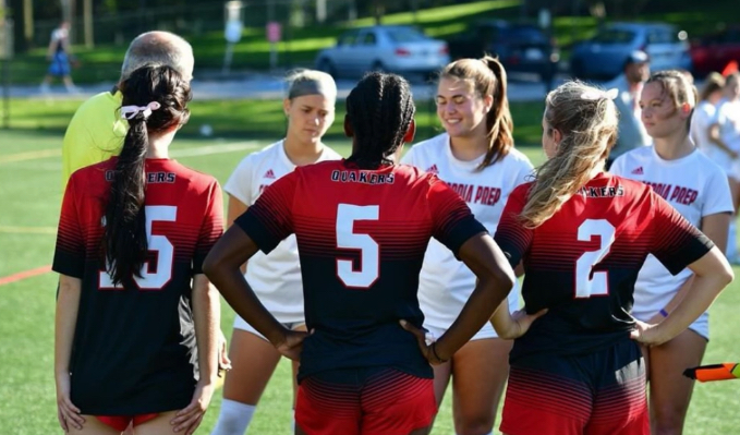 Seniors meet with captains of opposing team at start of the game. 