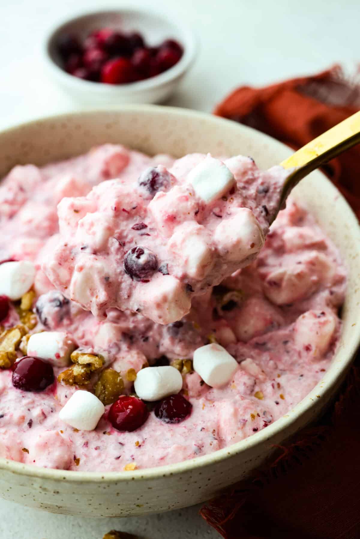 Mixing the topping and fluff together with a golden metal spoon.