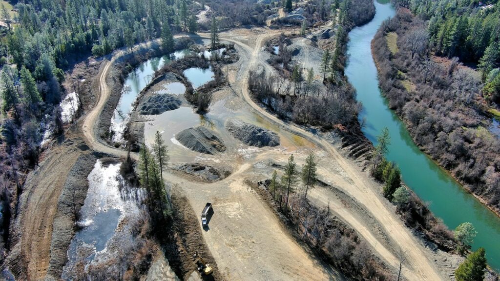 Aerial view of river with construction in floodplain