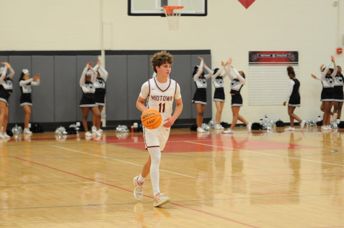 Junior point guard Luke Finley dribbles up the court during Midtown's game against North Atlanta on Nov. 14.The Knights won 52-47.