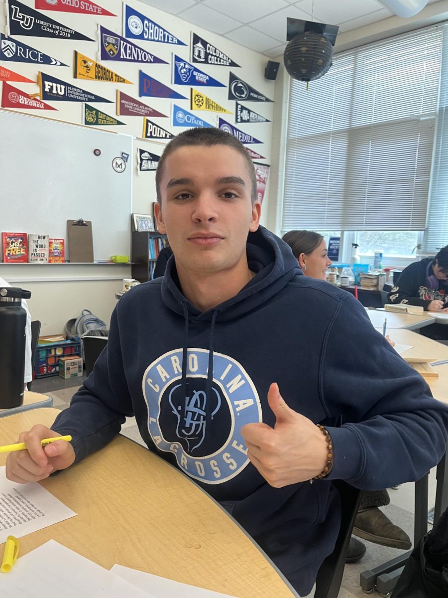 Senior Henry Sandrini poses in his 1A AP Literature class. 