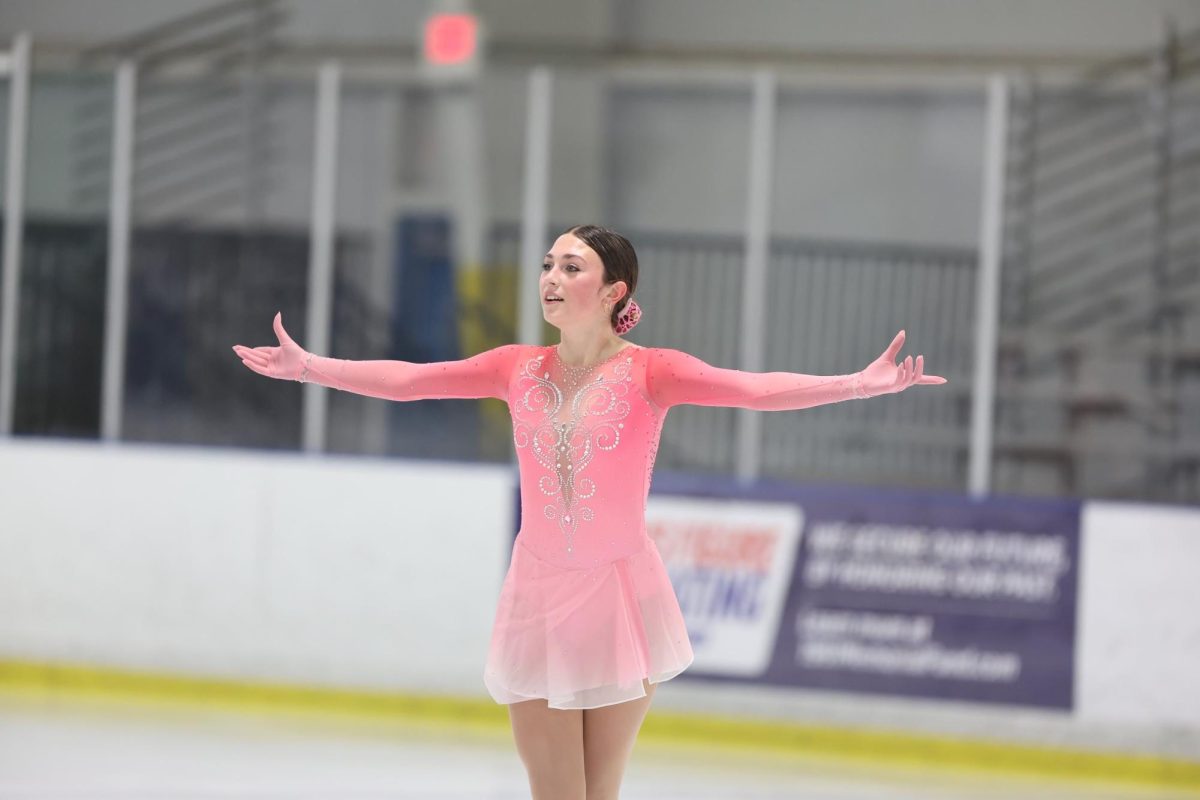 Nationally recognized junior Leia Beinenson poses on ice during a skating competition. 