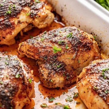 Crispy oven baked chicken thighs in white baking dish