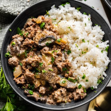 An overhead view of a bowl of ground beef stroganoff and rice.