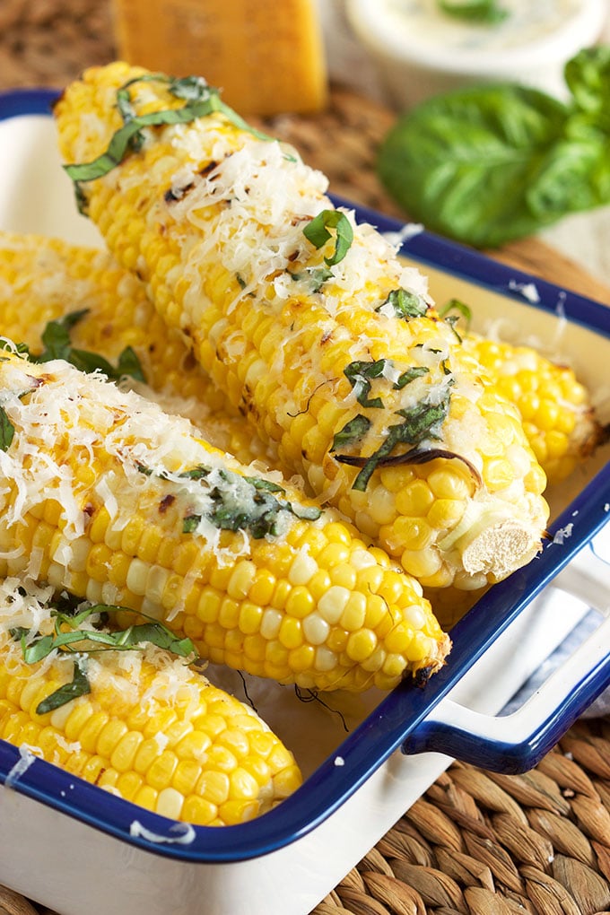 Super easy crowd pleaser, Basil Parmesan Grilled Corn on the Cob is the perfect summer side dish! | TheSuburbanSoapbox.com