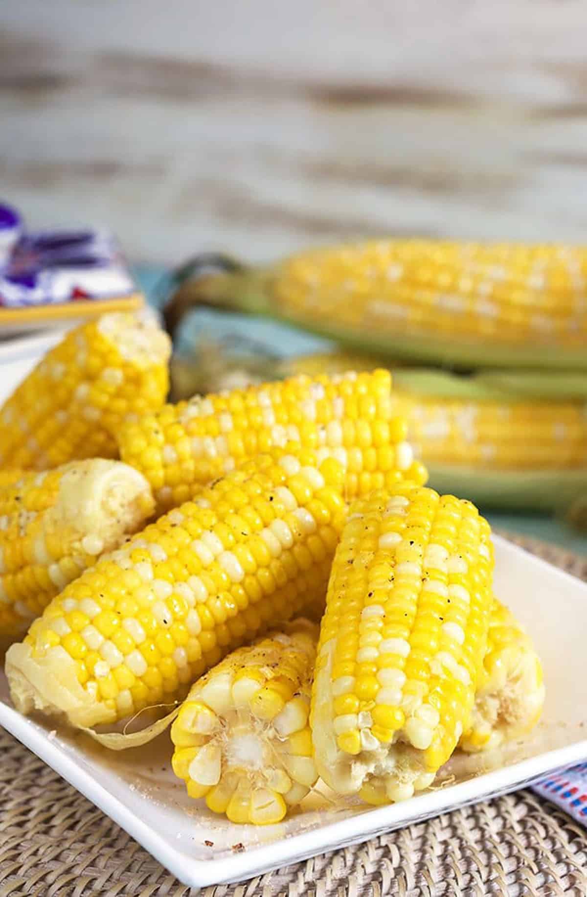 Corn on the cob on a white platter.