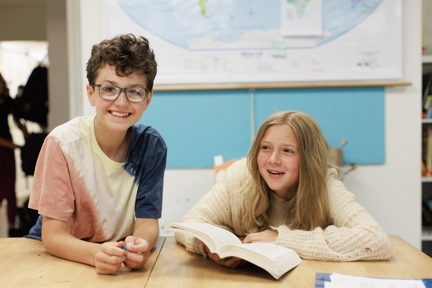 ES fifth sixth kids at table with book