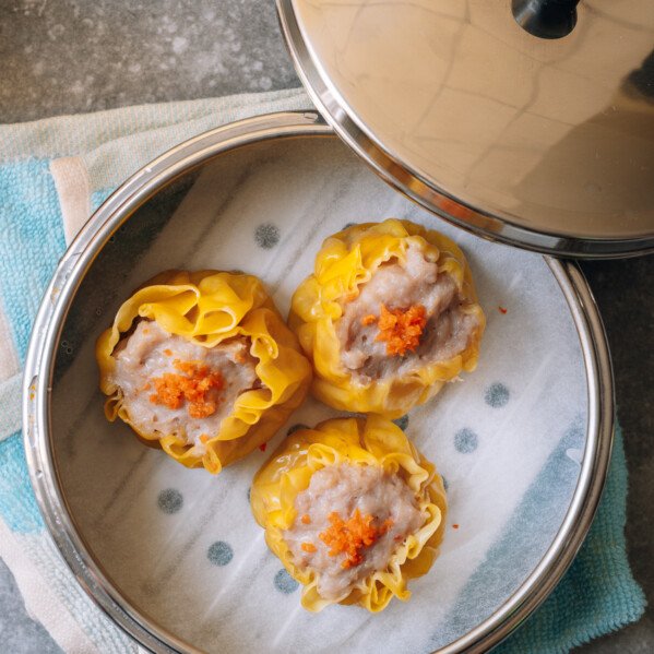 three steamed siu mai in metal dim sum basket