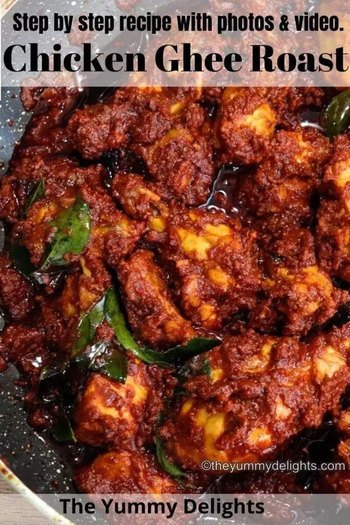 close-up image of mangalorean chicken ghee roast. It shows succulent pieces of chicken coated with spicy ghee roasted masala in a black color pan.