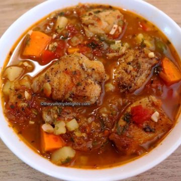 close-up of mediterranean chicken stew served in a white bowl.