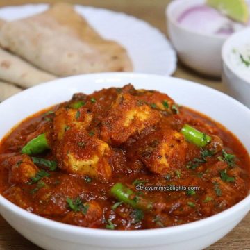 close-up of chicken pathia curry served in a white bowl.