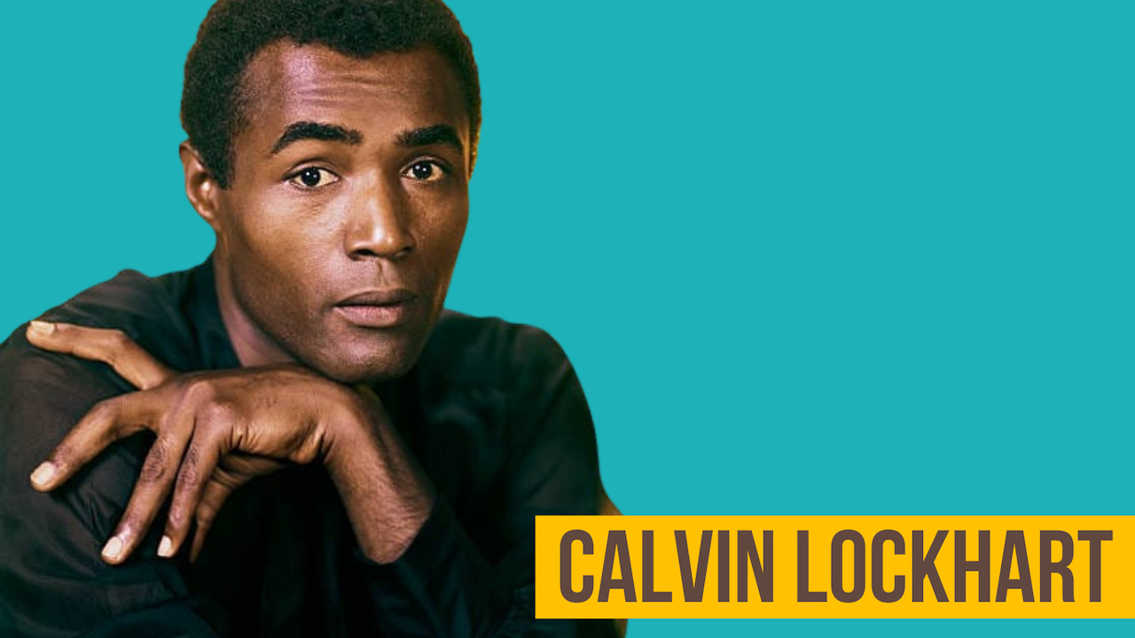 Headshot of actor Calvin Lockhart wearing a black shirt and staring at directly at the camera.