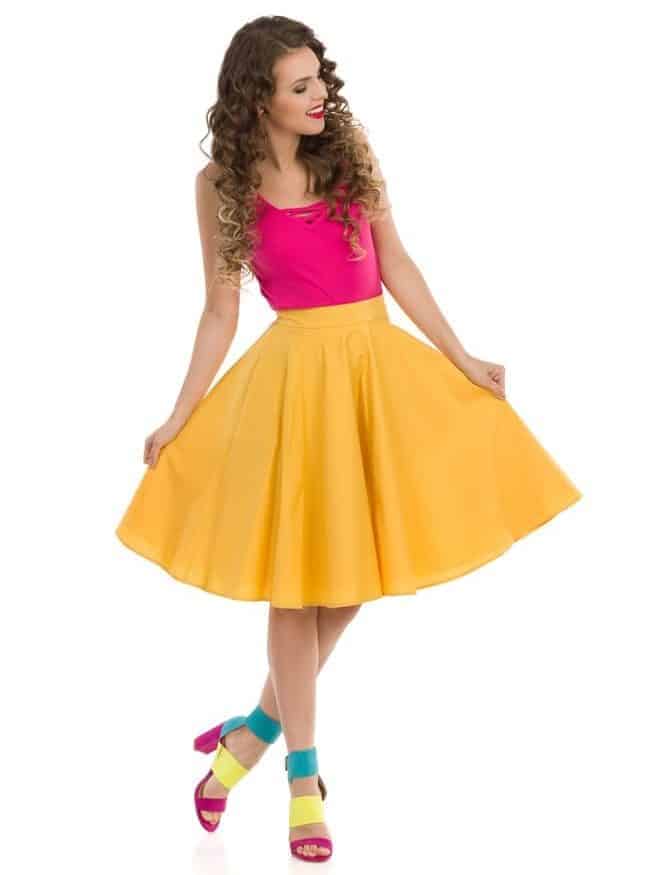 Woman presenting her circle cut yellow skirt.