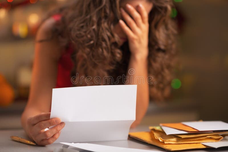 Closeup on stressed woman reading letter stock photo