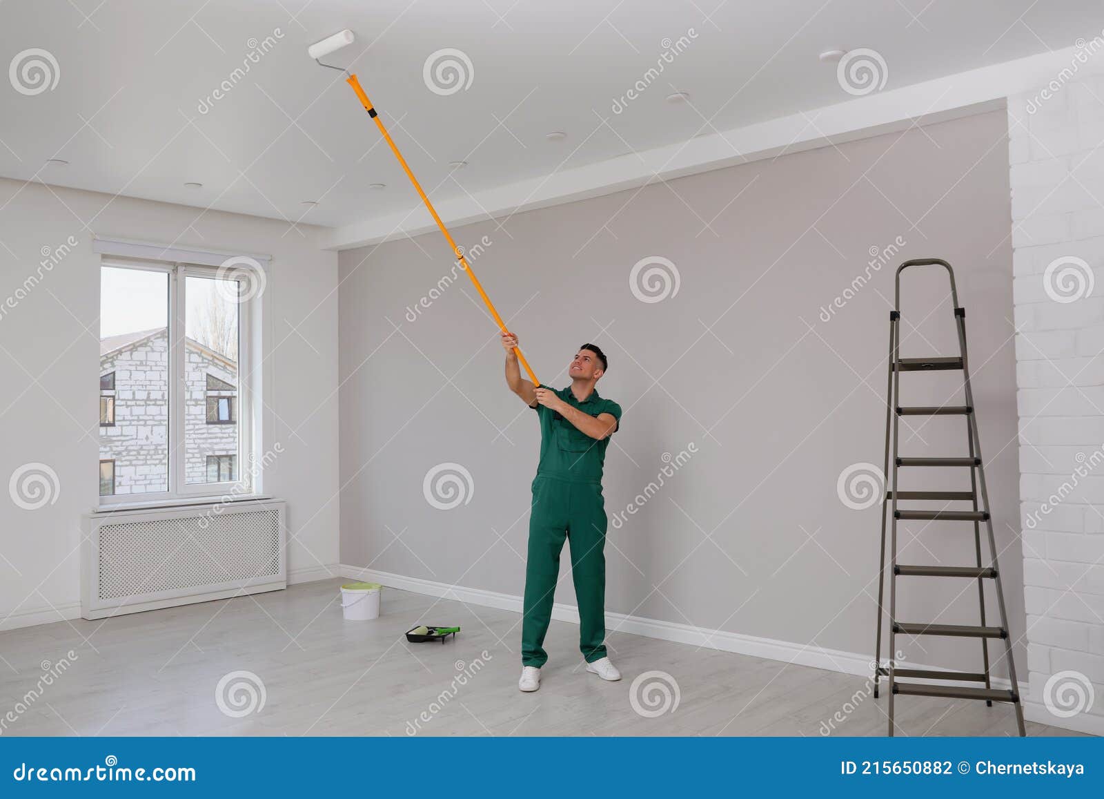 Man Painting Ceiling with Roller in Room Stock Photo - Image of house ...