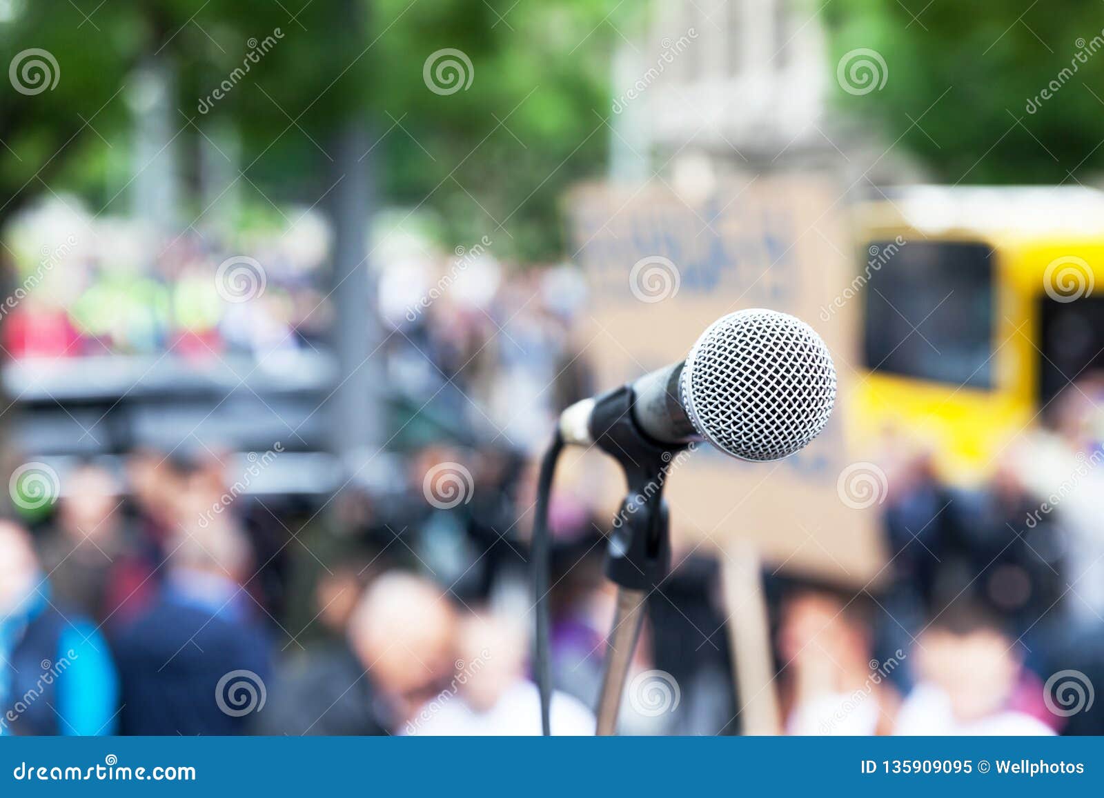 Microphone in Focus Against Blurred Protest or Public Demonstration ...