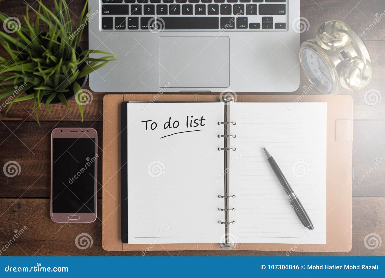 Notebook, Laptop, Clock, Smartphone and Journal on a Wooden Table with ...