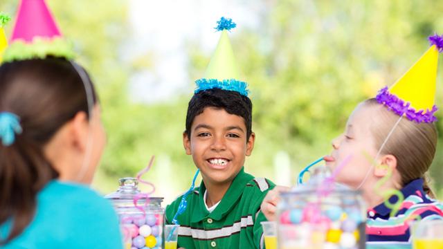 little boy smiling at a birthday joke