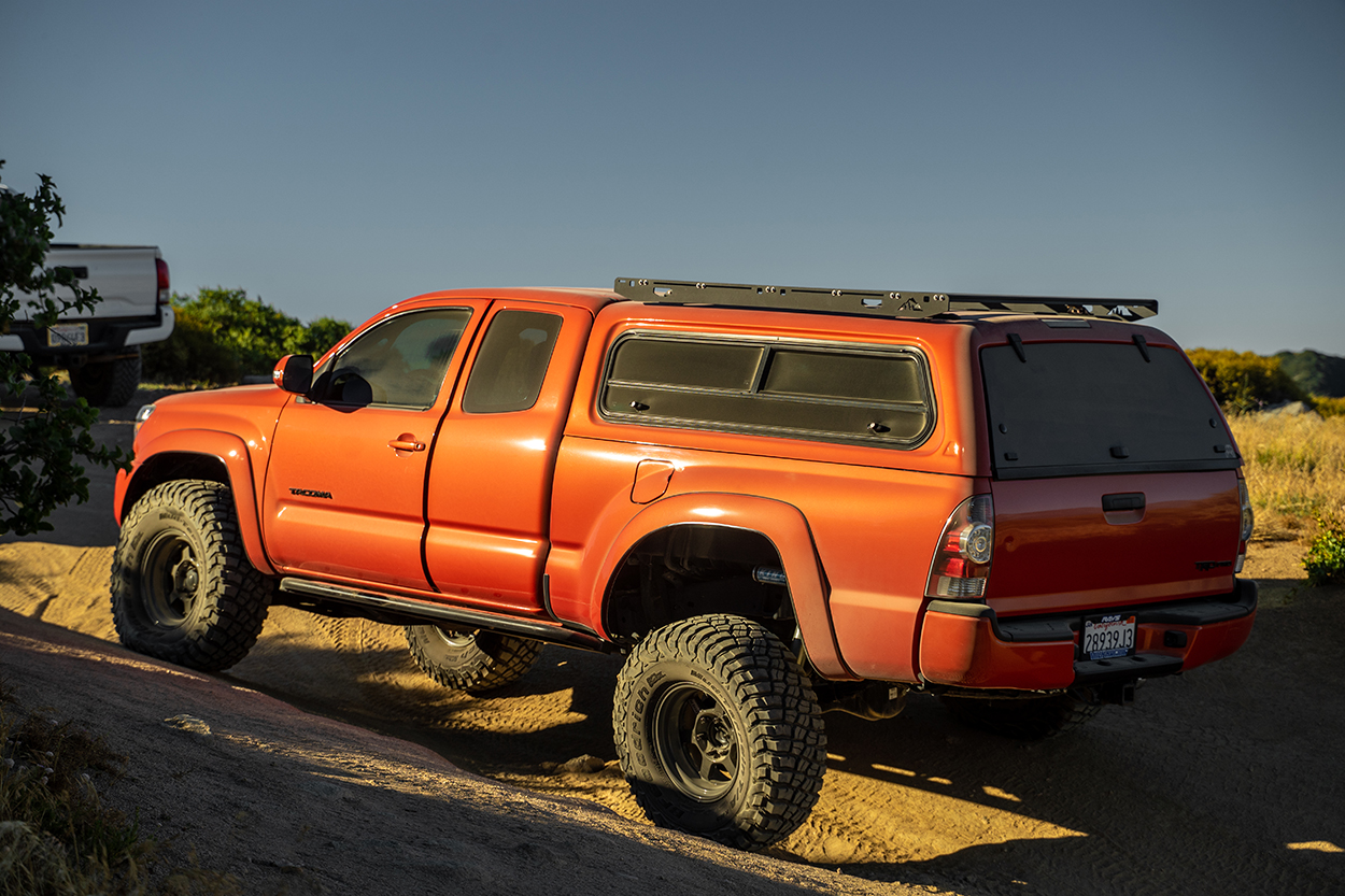 Orange Access Cab 2nd Gen Tacoma With LEER 100XR Camper Shell & Sherpa Bed Topper Roof Rack