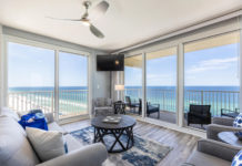 a living room with a view of the ocean