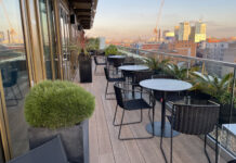 a patio with chairs and tables on a balcony