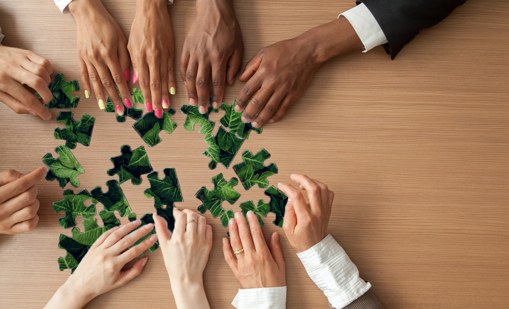 Employees putting together a puzzle