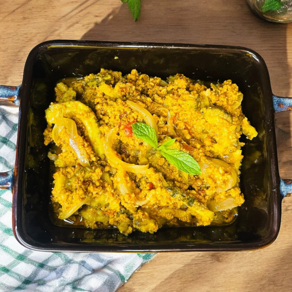 Keema karela arranged in black dish placed on wooden table