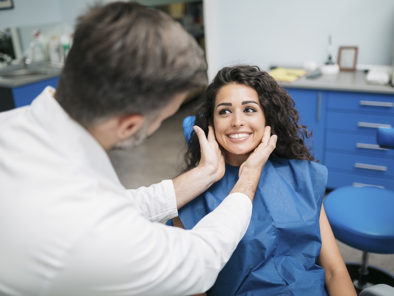 Young Caucasian female dental patient with dentist