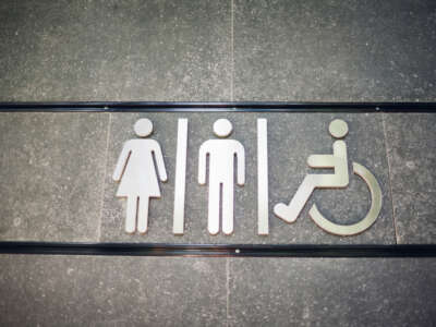 Restroom sign with figures for male, female and disabled people.