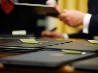 President Donald Trump signs executive orders in the Oval Office on January 20, 2025, in Washington, D.C.