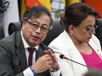 Colombia's President Gustavo Petro (L) speaks next to Honduras's President Xiomara Castro during the CELAC Summit in Buccament Bay, Saint Vincent and the Grenadines, on March 1, 2024.