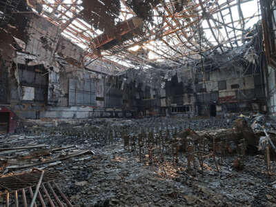 A burned fire extinguisher sits in the auditorium at the Eliot Arts Magnet Academy that was destroyed by the Eaton Fire on January 10, 2025, in Altadena, California.