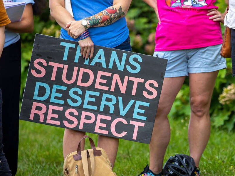 More than a dozen people attend a rally in support of trans youth in schools on June 26, 2023, outside the Fayette County Public Schools central office in Lexington, Kentucky.