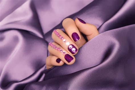 Female Hand with Purple Nail Design. Glitter Purple Nail Polish ...