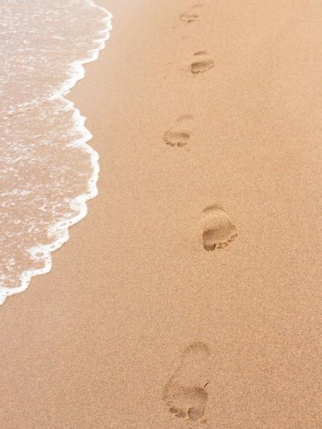 Premium Photo | Footprints in the sand on a beach