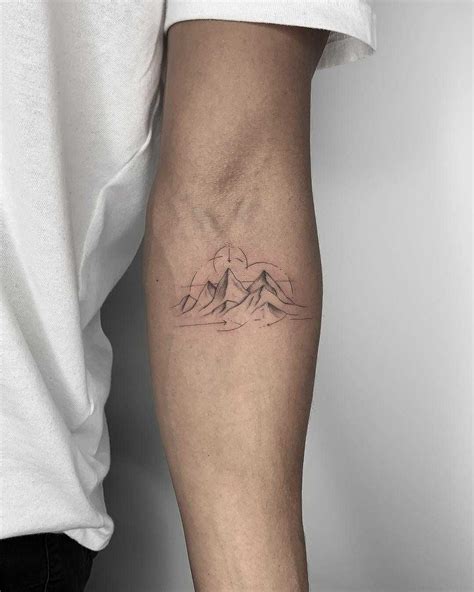 Beautiful minimalist mountains tattoo inked on the left forearm by Conz ...