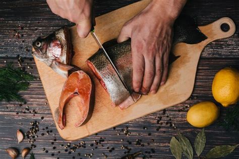 Premium Photo | Cook cuts with a knife for cooking fresh trout