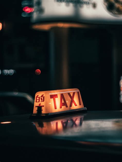 Taxi sign on car riding on city street · Free Stock Photo