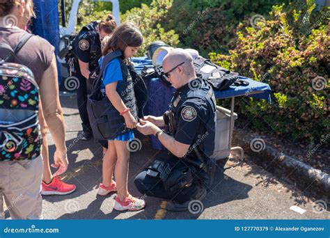 Police Officer Putting Kevlar Vest on a Child Editorial Stock Image ...